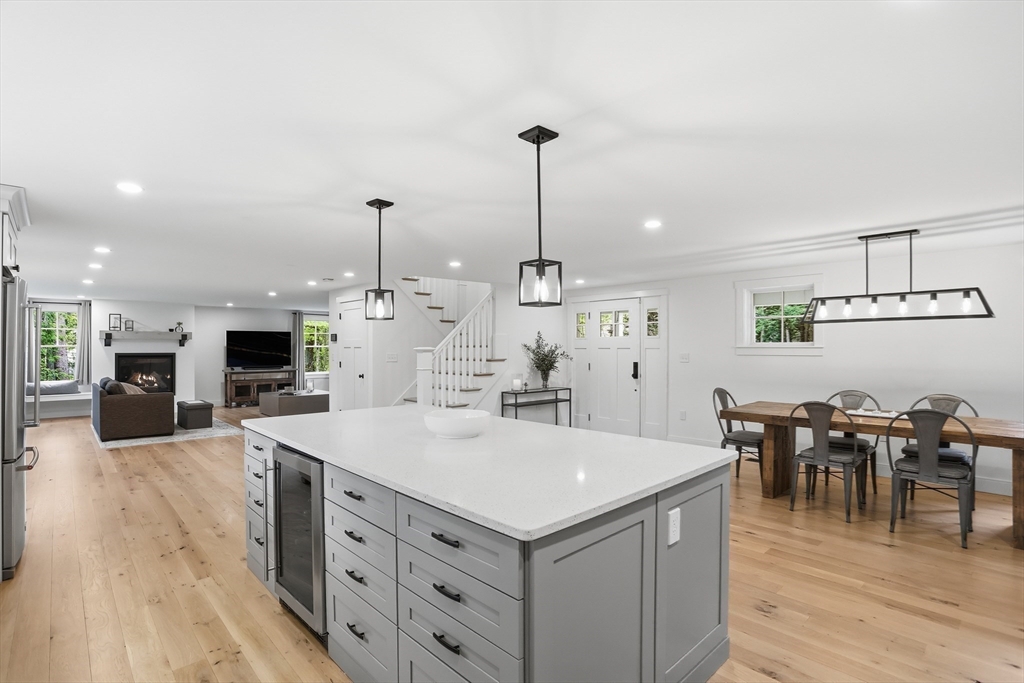 136 Holden Wood Road Concord, MA 01742 - Photo 10 of 31 a large kitchen with kitchen island a sink table and chairs