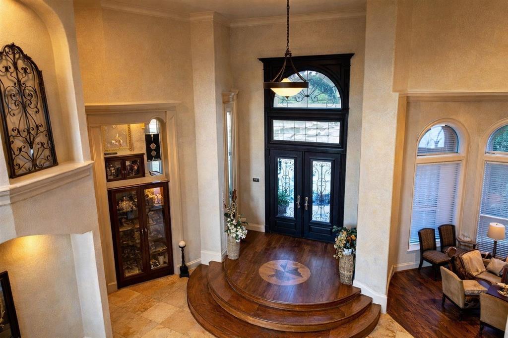 1919 Kings Pass Heath, TX 75032 - Photo 6 of 38 Grand entryway featuring double doors with decorative glass panels, an arched transom window, and a wood floor with an inlaid design