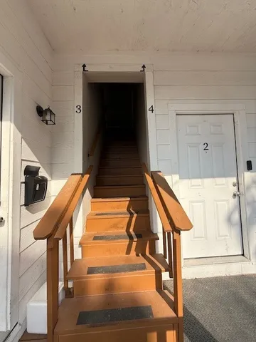 a balcony view with couches and wooden floor