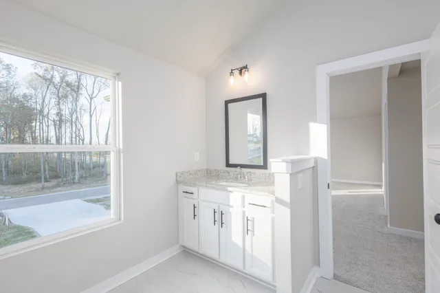 a kitchen with a stove a sink and a window