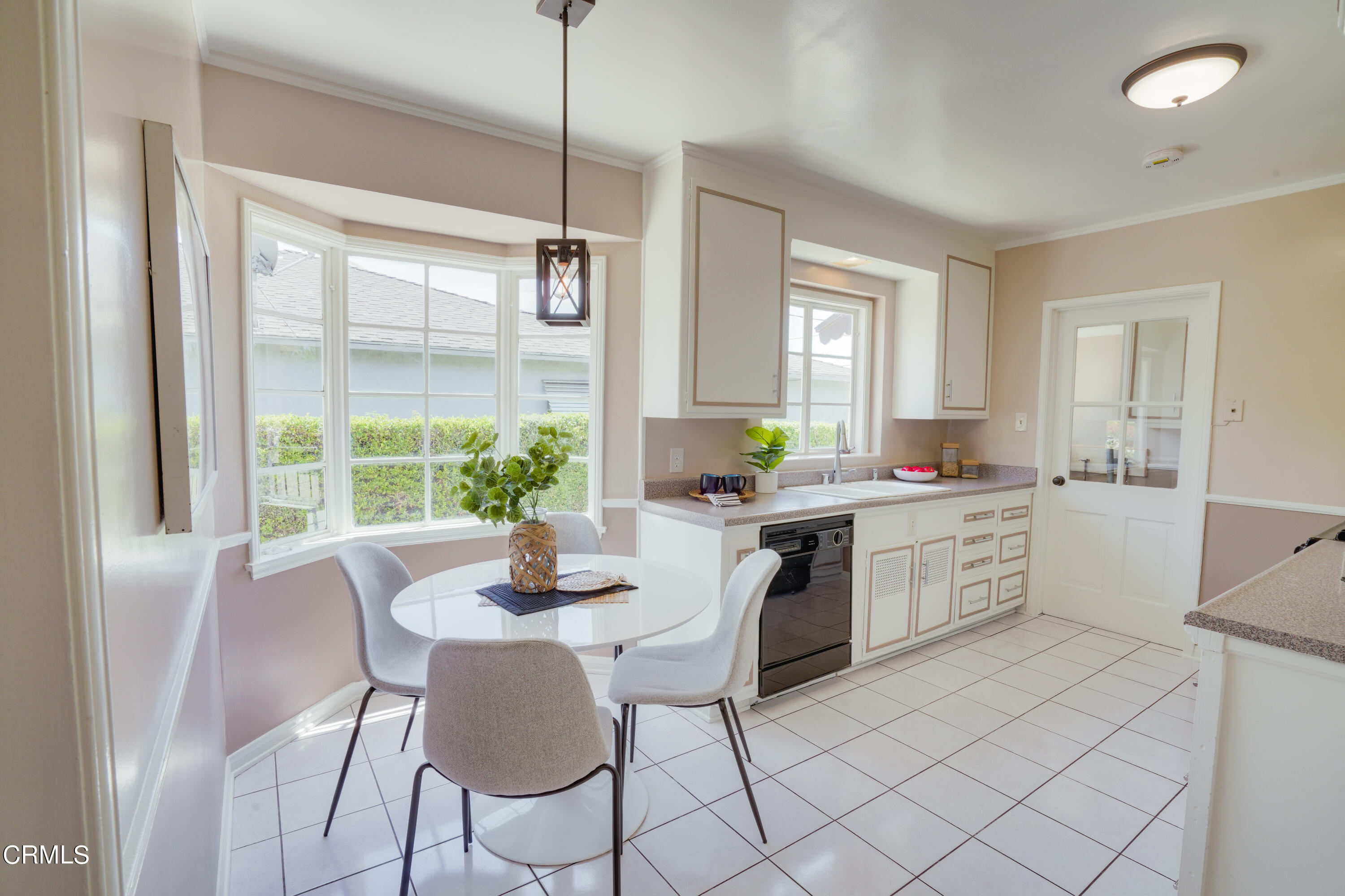 2540 Lambert Drive Pasadena, CA 91107 - Photo 14 of 30 a kitchen with a dining table chairs and white cabinets