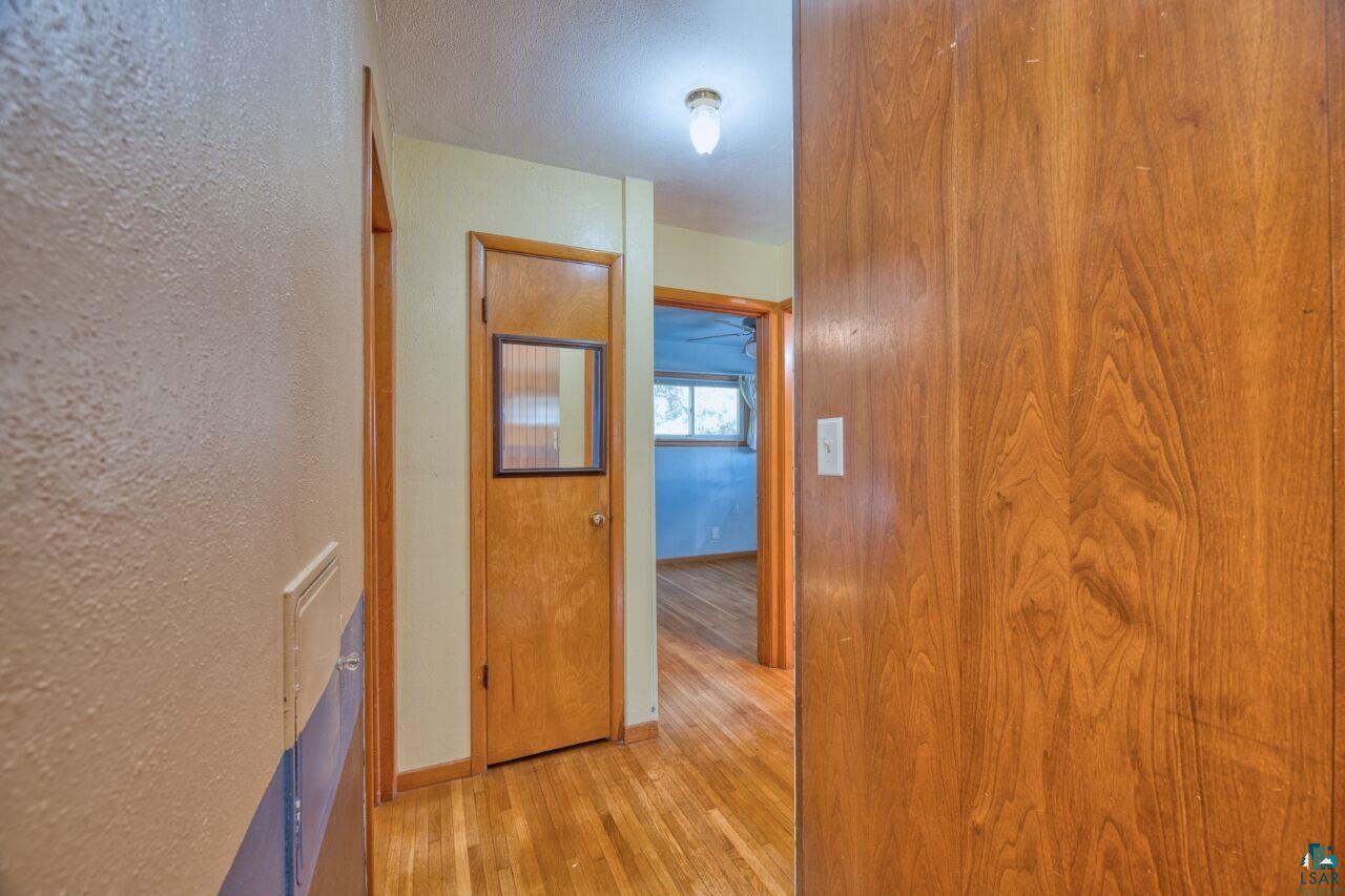 5316 Highway 110 Aurora, MN 55705 - Photo 12 of 35 Corridor with light wood-style flooring and a textured wall