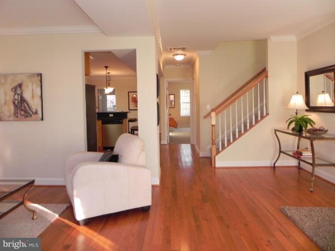 4933 Lee Street Northeast Washington, DC 20019 - Photo 2 of 21 a living room with furniture and a wooden floor