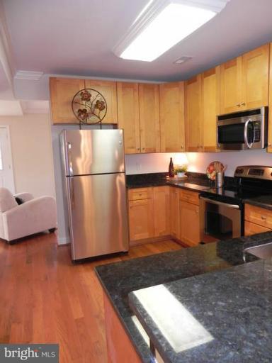 4933 Lee Street Northeast Washington, DC 20019 - Photo 3 of 21 a kitchen with stainless steel appliances granite countertop a refrigerator sink and stove