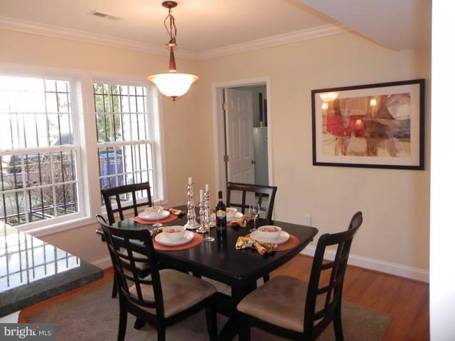 4933 Lee Street Northeast Washington, DC 20019 - Photo 10 of 21 a view of a dining room with furniture window and wooden floor