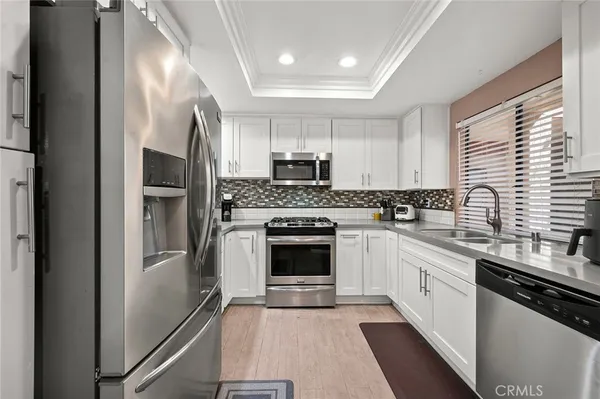 a kitchen with cabinets and stainless steel appliances