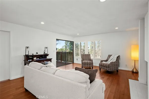 a living room with furniture and floor to ceiling window