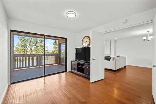 a view of a livingroom with furniture wooden floor and window