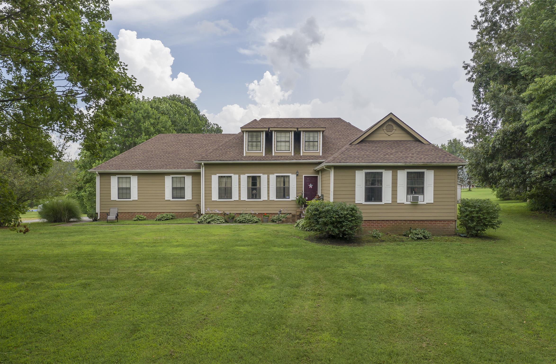 3013 York Road Pleasant View, TN 37146 - Photo 3 of 10 a front view of a house with a garden