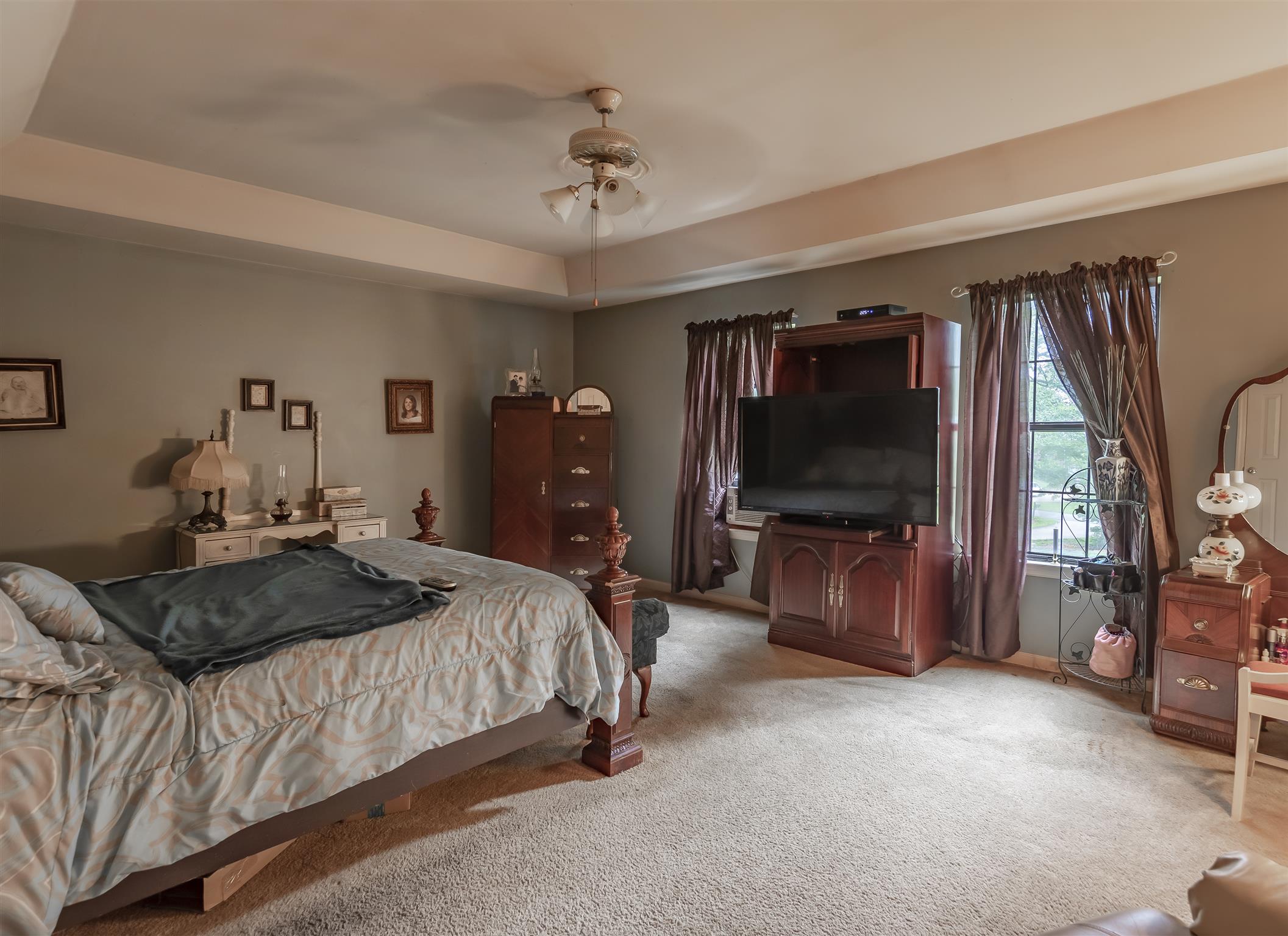 3013 York Road Pleasant View, TN 37146 - Photo 6 of 10 a bedroom with a bed and a flat tv screen on wall