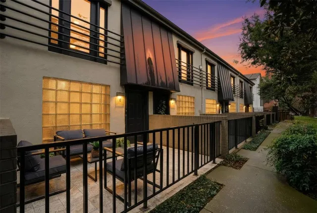 a view of a house with a wooden fence