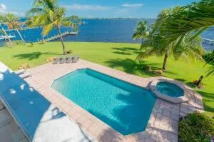 a view of house with swimming pool outdoor seating