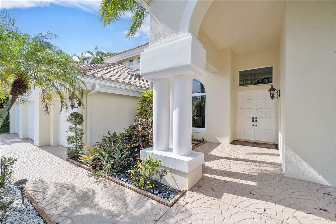 3110 Northwest 63rd Street Boca Raton, FL 33496 - Photo 21 of 62 a front view of a house with garden