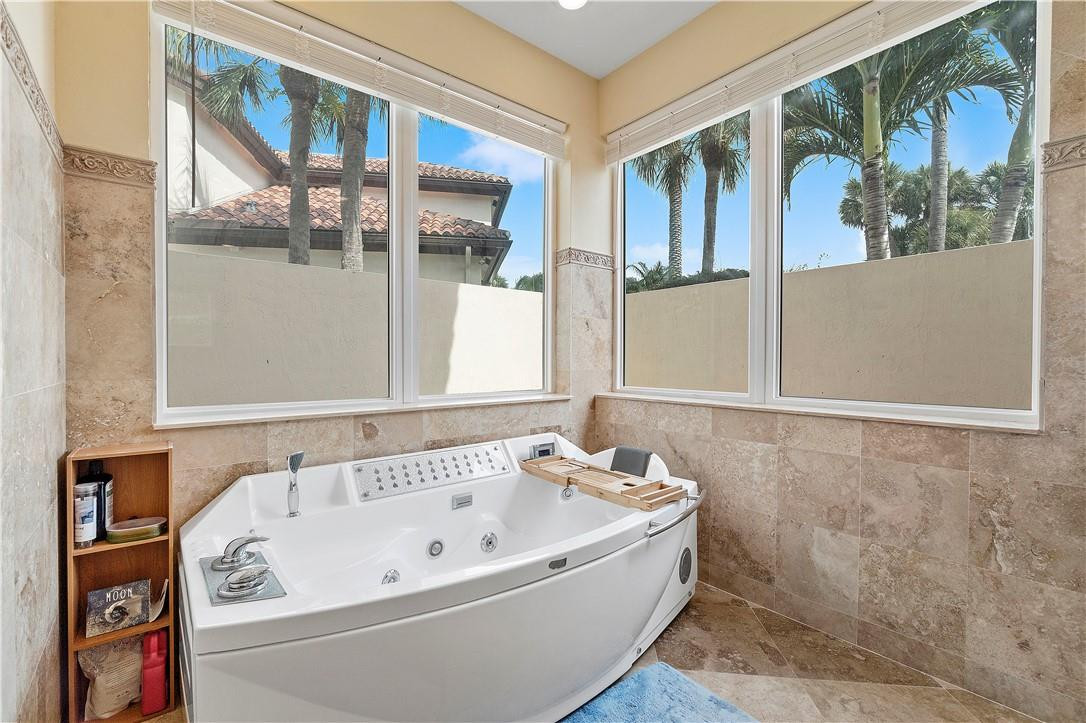 3110 Northwest 63rd Street Boca Raton, FL 33496 - Photo 54 of 62 a white bath tub sitting next to a window