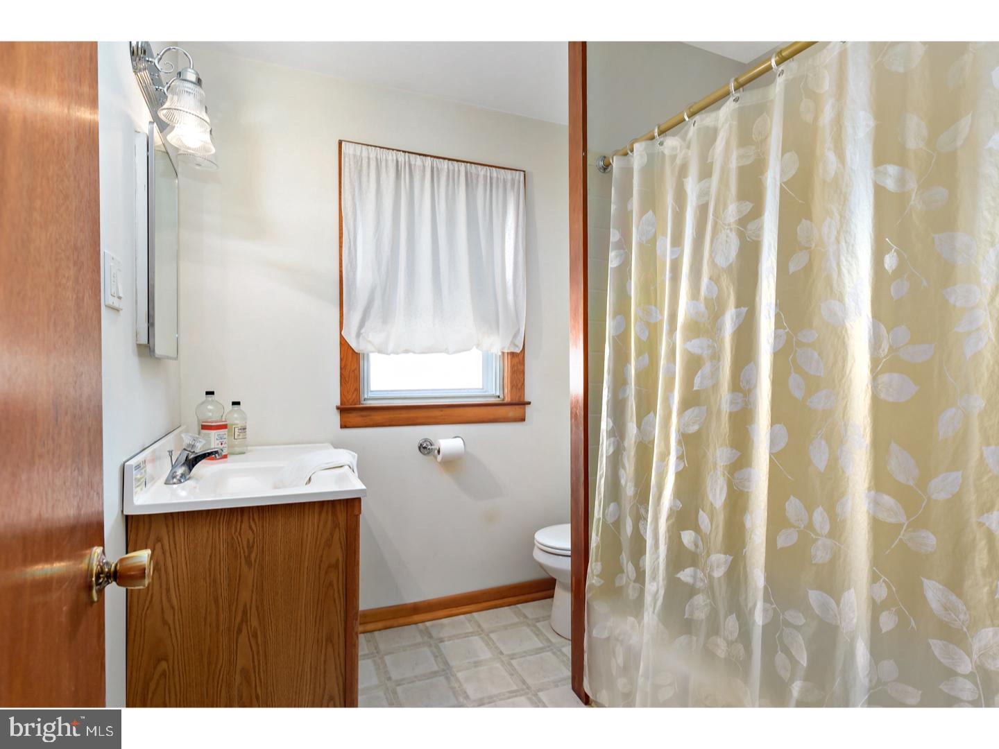 522 Heulings Avenue Riverside, NJ 08075 - Photo 19 of 22 a bathroom with a sink and mirror