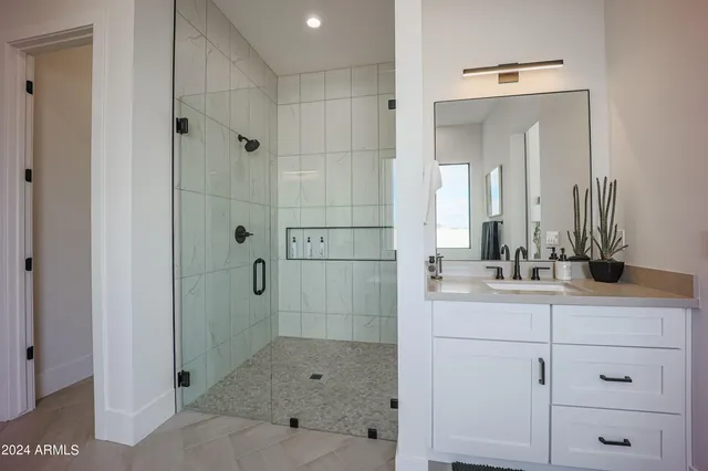 a bedroom with a bed and two windows