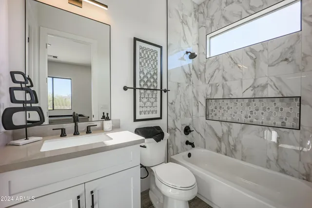 a bathroom with double vanity sinks and a mirror
