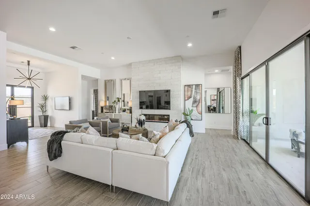 a large room with lots of appliances wooden floor and a large window