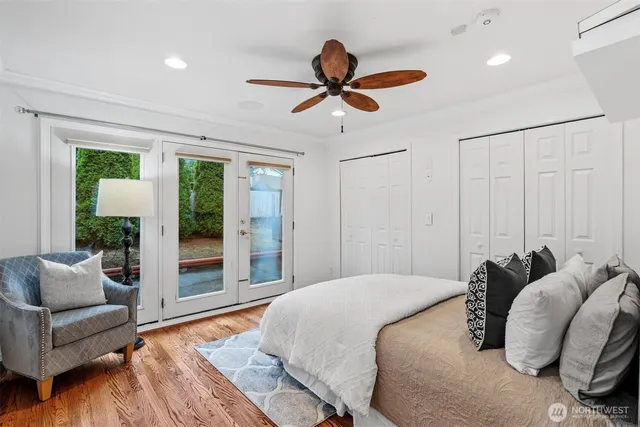 a bedroom with a bed and a ceiling fan