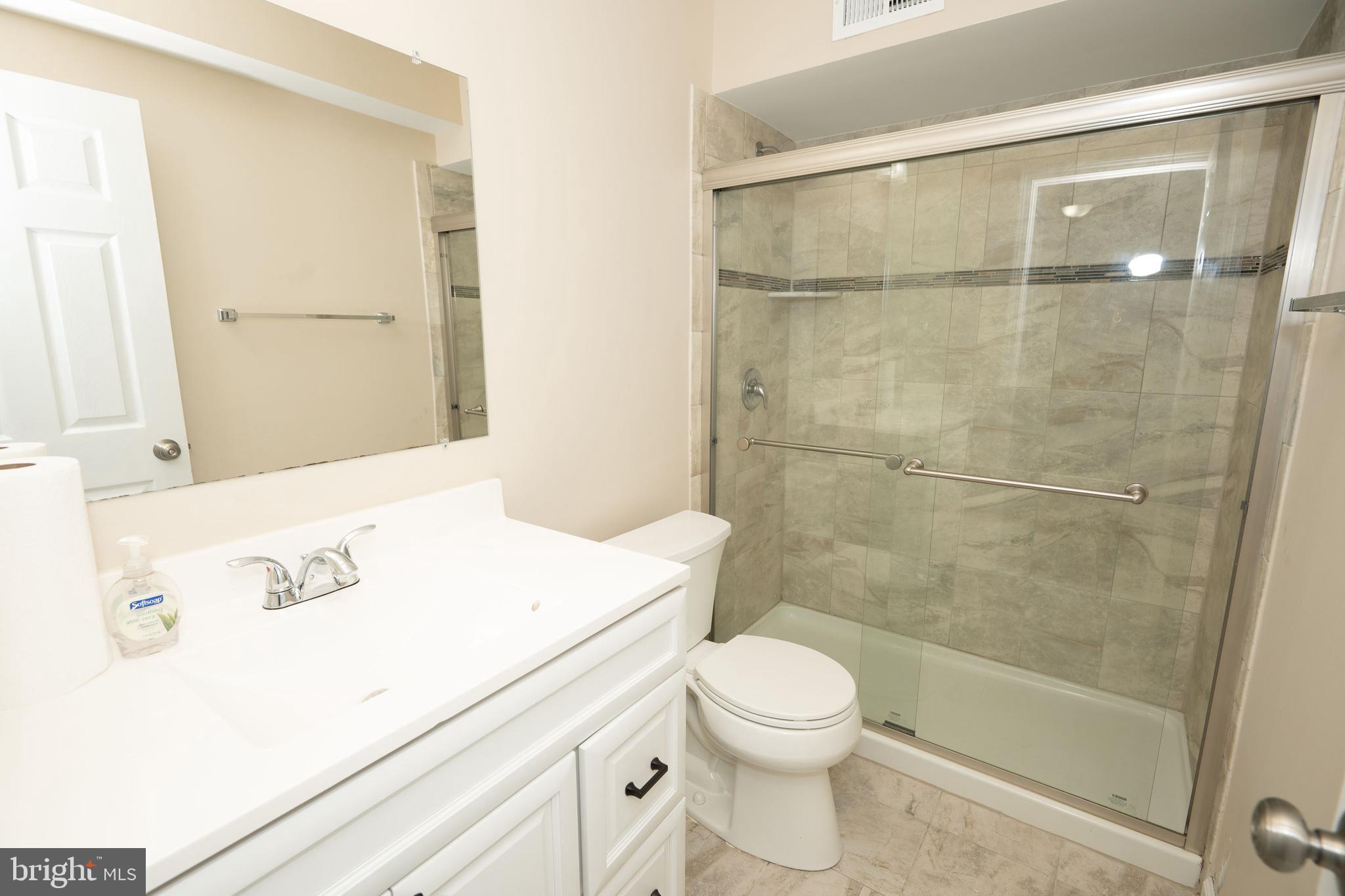 411 Stiles Avenue, Unit E3 Maple Shade, NJ 08052 - Photo 14 of 30 a bathroom with a shower a toilet and a sink
