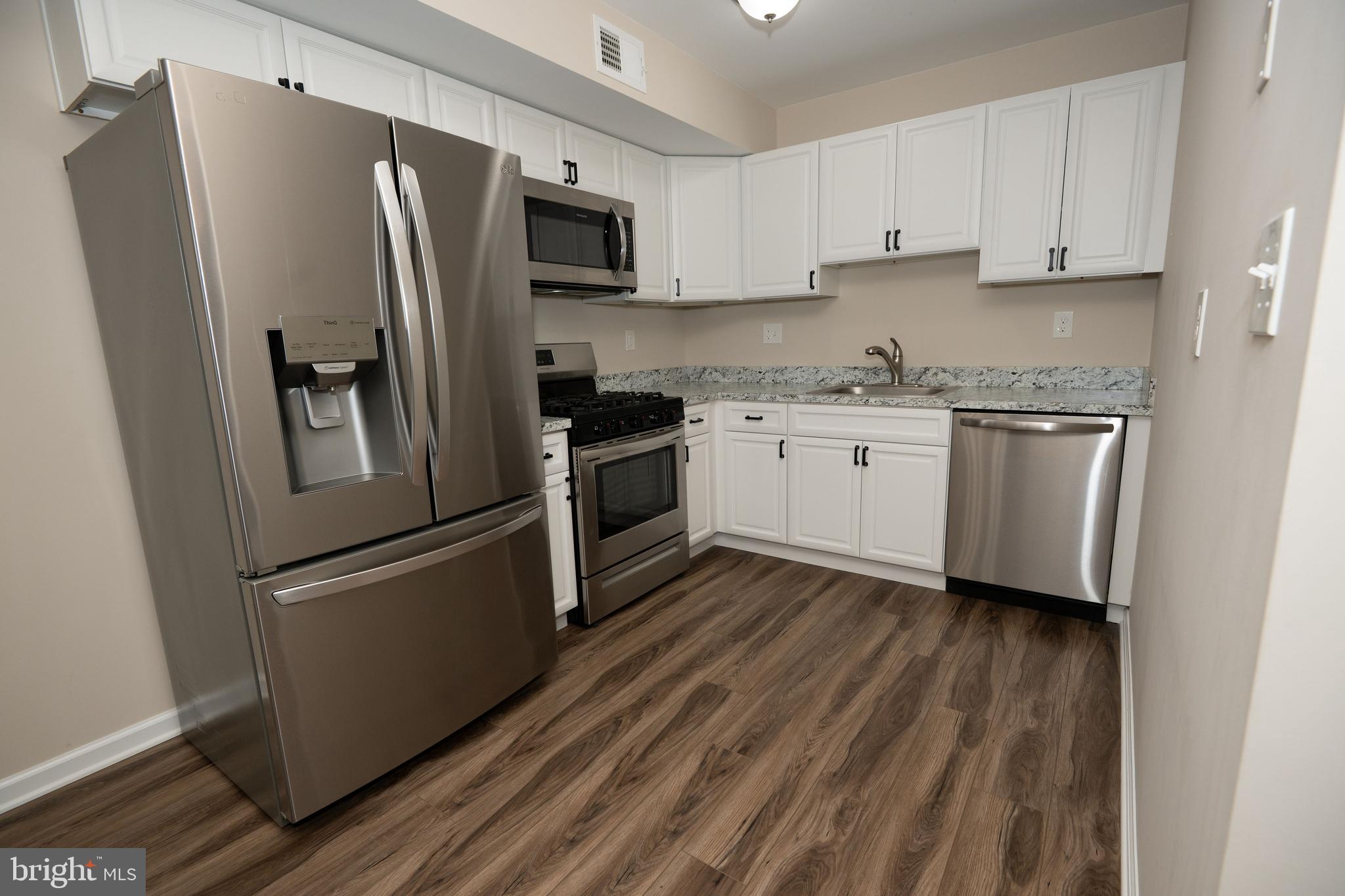 411 Stiles Avenue, Unit E3 Maple Shade, NJ 08052 - Photo 19 of 30 a kitchen with stainless steel appliances a refrigerator sink and microwave