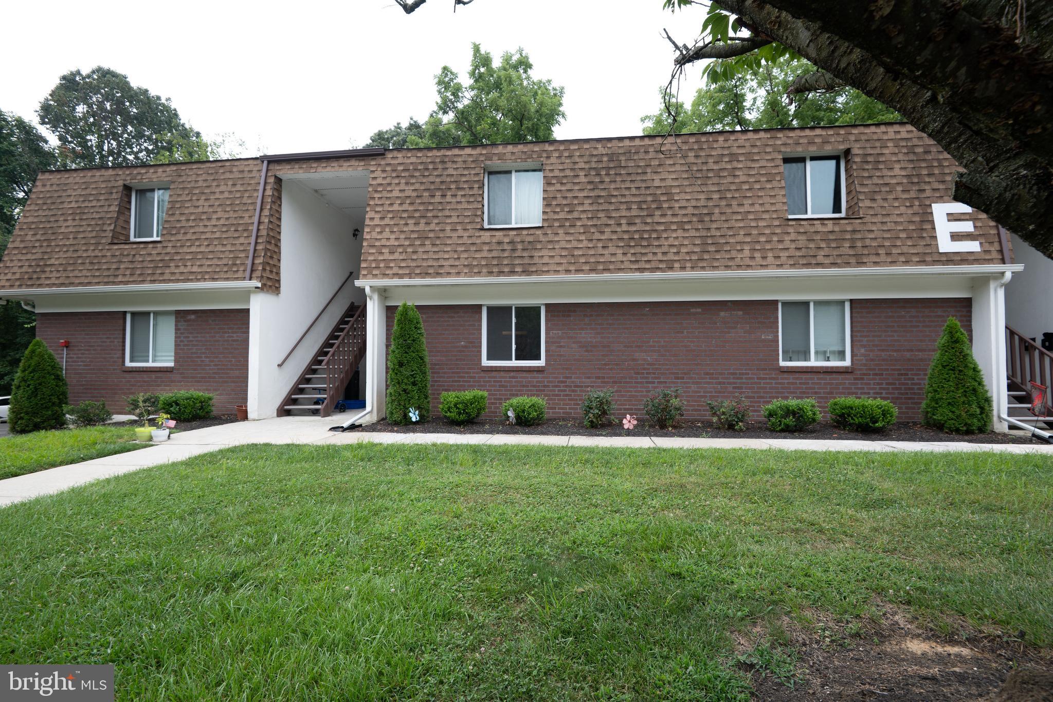 411 Stiles Avenue, Unit E3 Maple Shade, NJ 08052 - Photo 2 of 30 a front view of a house with a yard and garage