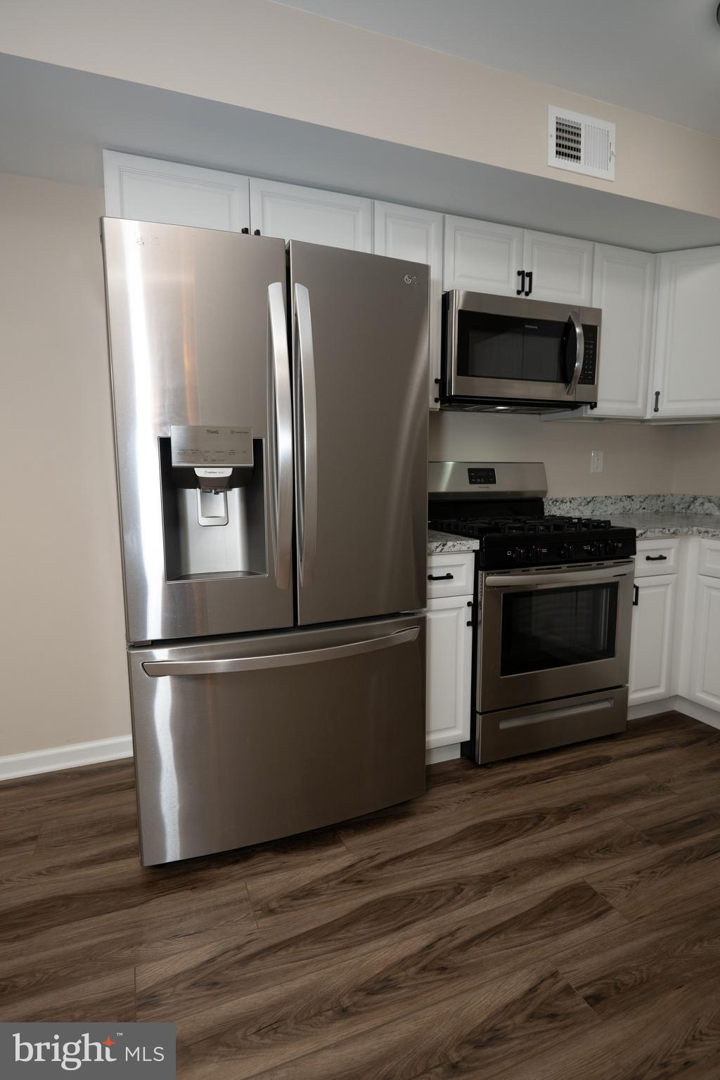 411 Stiles Avenue, Unit E3 Maple Shade, NJ 08052 - Photo 21 of 30 a metallic refrigerator freezer sitting in a kitchen