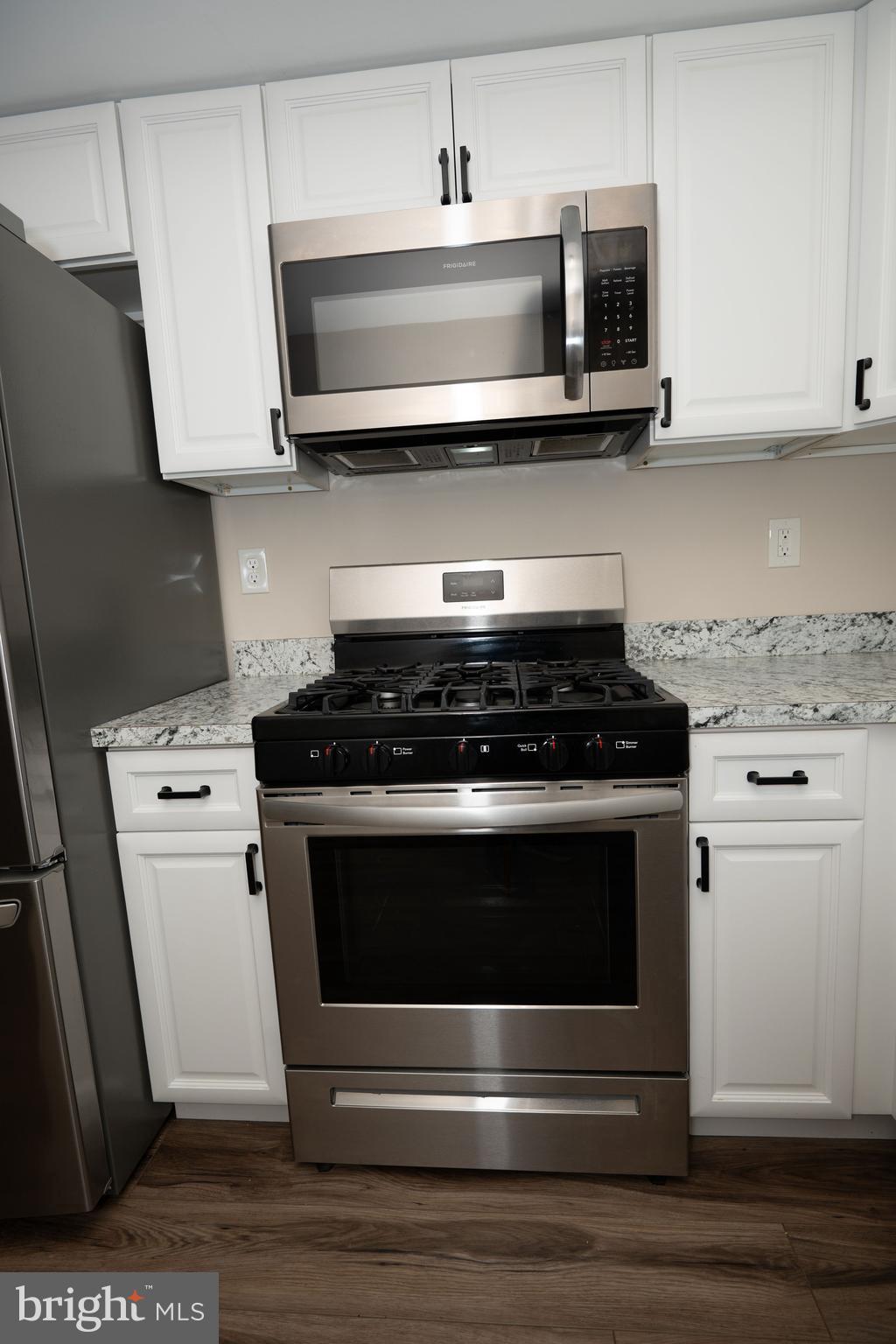 411 Stiles Avenue, Unit E3 Maple Shade, NJ 08052 - Photo 22 of 30 a kitchen with stainless steel appliances granite countertop a stove and a microwave