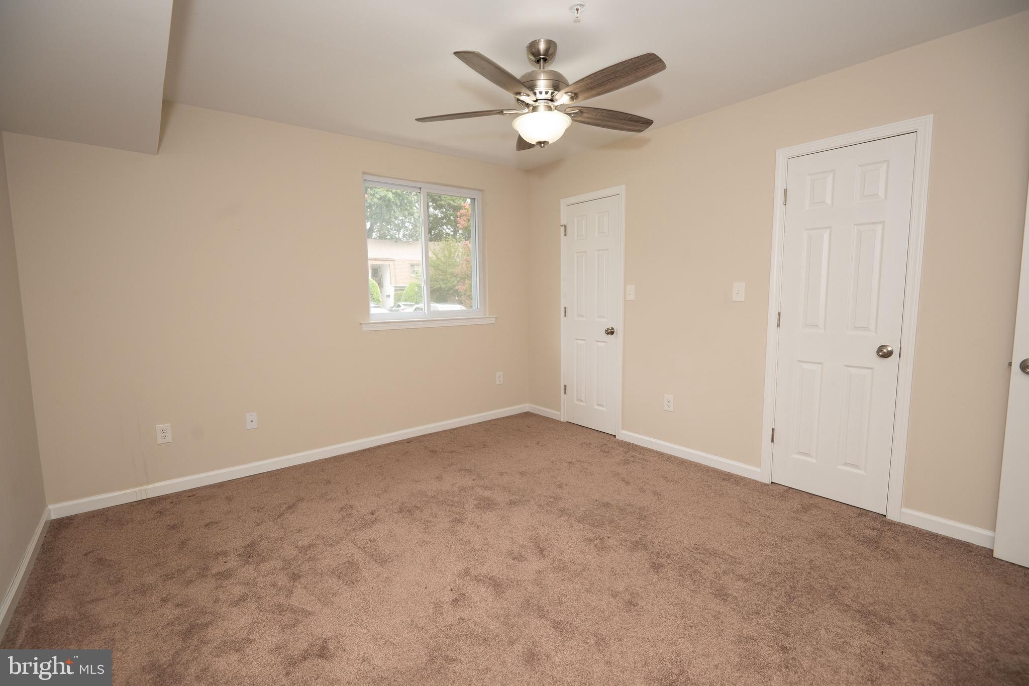 411 Stiles Avenue, Unit E3 Maple Shade, NJ 08052 - Photo 26 of 30 an empty room with a window and a fan