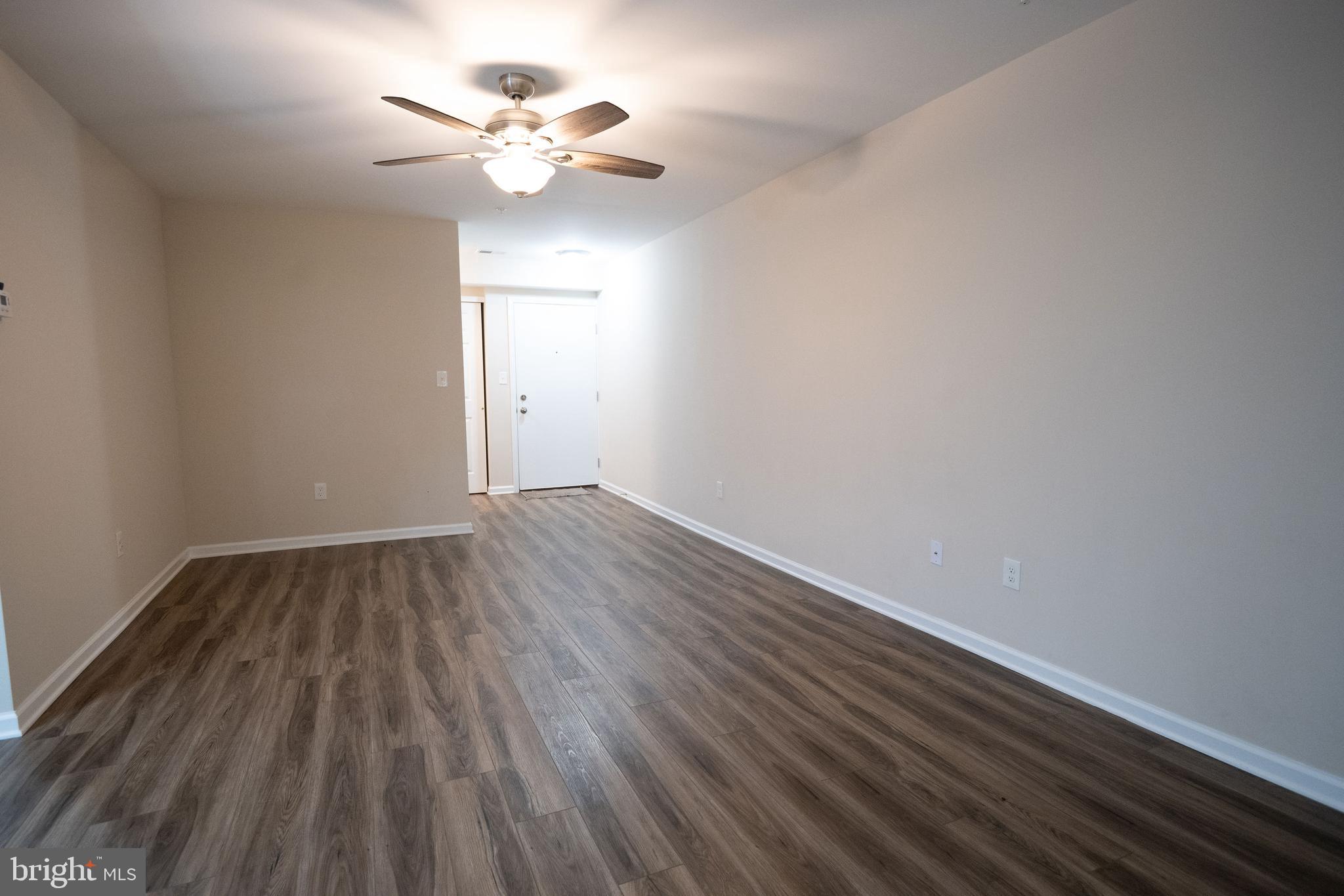 411 Stiles Avenue, Unit E3 Maple Shade, NJ 08052 - Photo 7 of 30 wooden floor in an empty room with a window