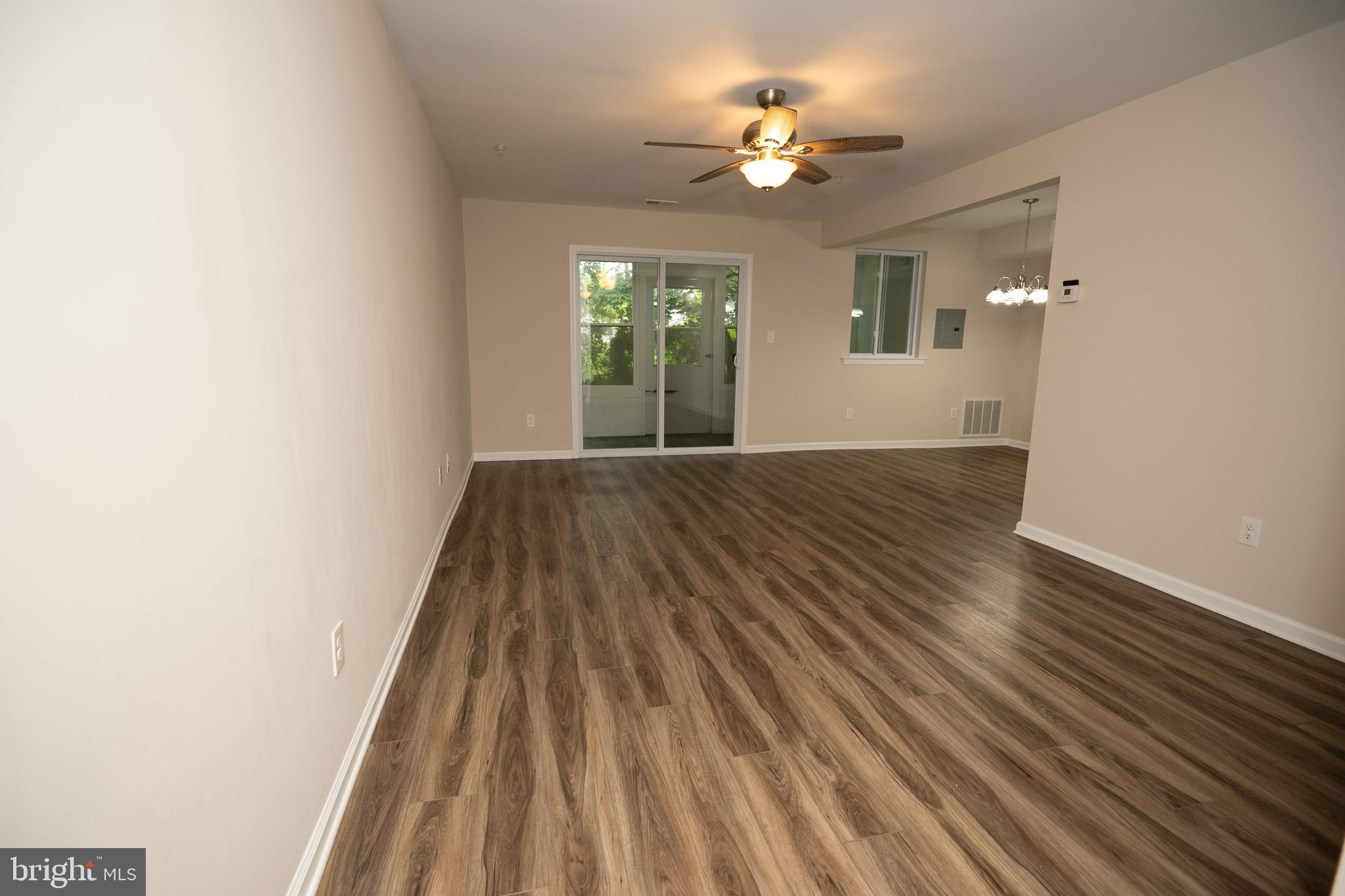 411 Stiles Avenue, Unit E3 Maple Shade, NJ 08052 - Photo 8 of 30 wooden floor in an empty room with a window