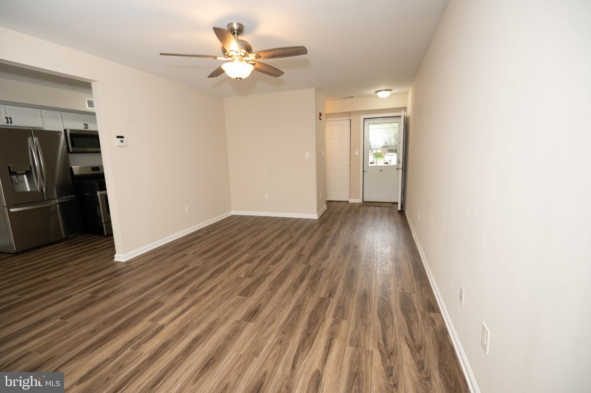 411 Stiles Avenue, Unit E3 Maple Shade, NJ 08052 - Photo 9 of 30 a view of an empty room with wooden floor