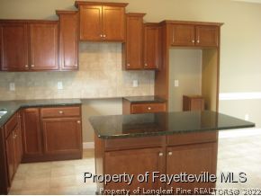 Lot 104 Carl Steiner Road Fayetteville, NC 28311 - Photo 4 of 15 a kitchen with granite countertop a sink and cabinets