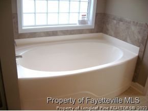 Lot 104 Carl Steiner Road Fayetteville, NC 28311 - Photo 8 of 15 a bath tub sitting in a bathroom next to a window