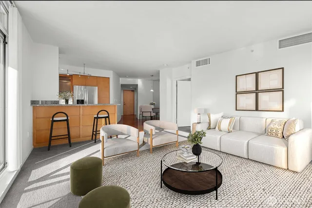 a living room with furniture and a potted plant