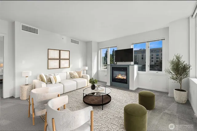 a living room with furniture a fireplace and windows
