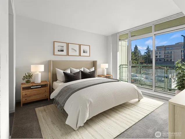 a bedroom with a large bed and a large window