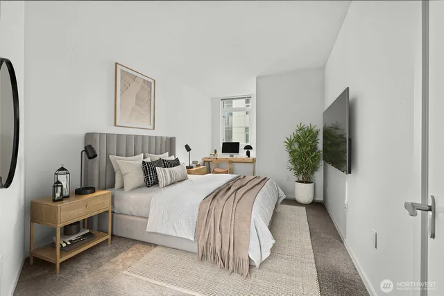 a bedroom with a bed and a flat screen tv