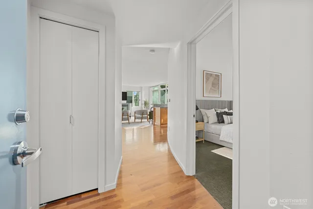 a view of a bedroom with a bed and wooden floor