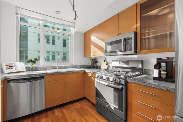 a kitchen with stainless steel appliances granite countertop a stove and a sink