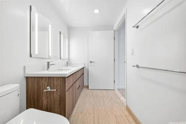 a bathroom with a sink a toilet a shower and a mirror