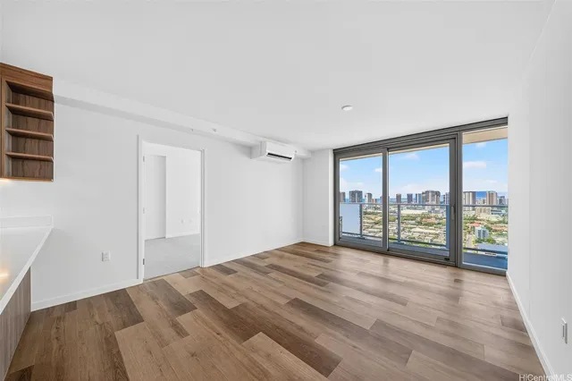 a view of a bedroom with wooden floor and balcony