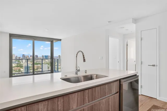 a kitchen with a sink and large window