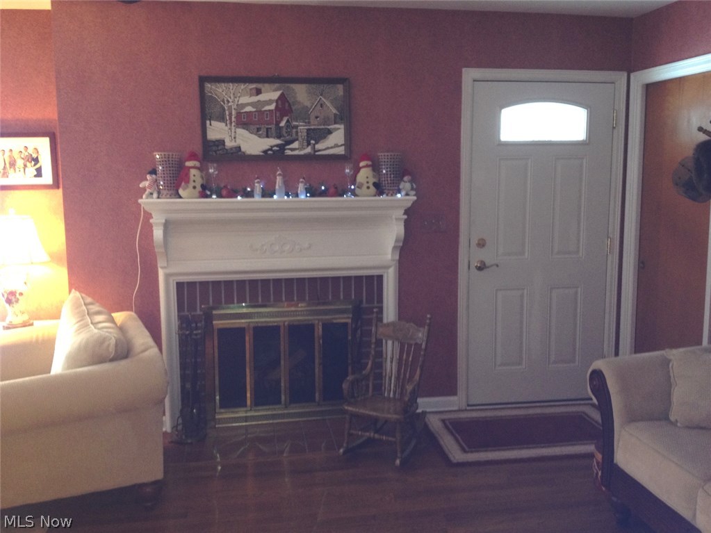 303 Bittersweet Road Akron, OH 44333 - Photo 16 of 20 VIEW OF WOODBURNING FIREPLACE & NEWER ENTRY DOOR IN LIVING ROOM.