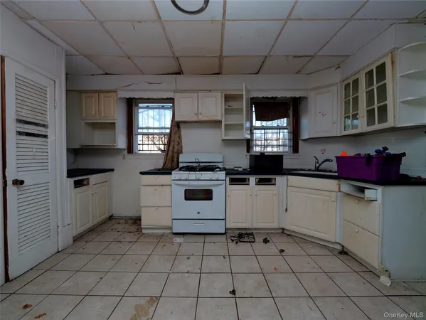 a kitchen with a stove a sink and a refrigerator