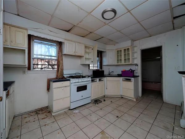 a kitchen with a stove a sink and a refrigerator