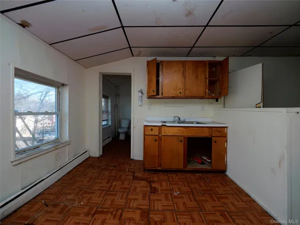 a view of entryway with kitchen