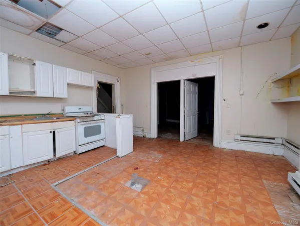 a kitchen with stainless steel appliances kitchen island granite countertop a sink cabinets and wooden floor