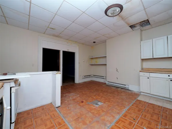 a view of a room with cabinets and wooden floor