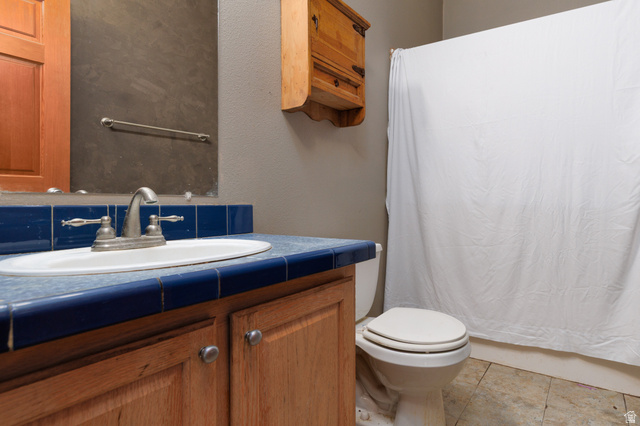 3902 Beaver Creek Road Kamas, UT 84036 - Photo 19 of 33 Full bath featuring vanity, a textured wall, and light tile patterned flooring